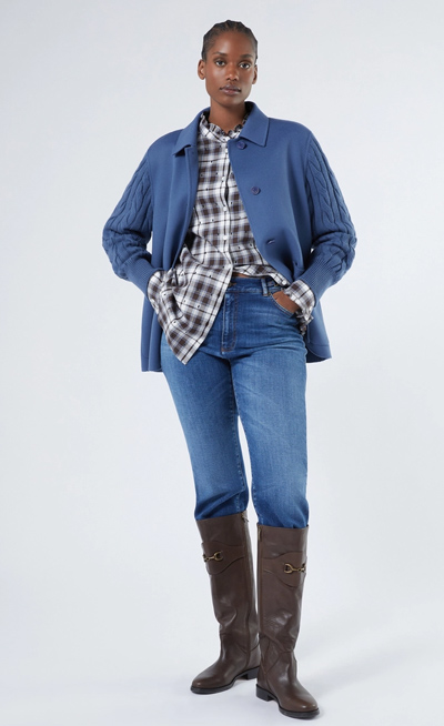 modella indossa completo autunnale stivali alti in pelle, jeans, camicia flanella a quadri, giacca in flanella blu jeans